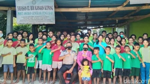 Ipda Yunus Labba bersama istrinya, Marselina Wunda Bali, berfoto dengan anak-anak Panti Asuhan Generasi Pengubah, Jumat (2/8/2024). (Simon Selly/detikBali)