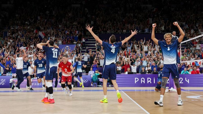 PARIS, FRANCE - AUGUST 7: Barthelemy Chinenyeze #1 of Team France, Jean Patry #4 of Team France, Antoine Brizard #11 of Team France and teammates celebrate the victory of the Mens Semifinals match between Team Italy and Team France on day twelve of the Olympic Games Paris 2024 at Paris Arena on August 7, 2024 in Paris, France. (Photo by Catherine Steenkeste/Getty Images)