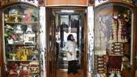 Warga menjajal pakaian adat yang akan disewanya di Medan, Sumatera Utara, Sabtu (10/8/2024).