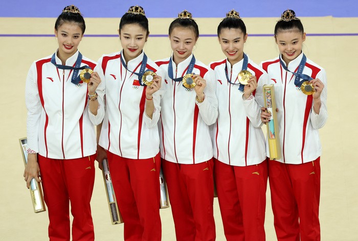 Paris 2024 Olympics - Rhythmic Gymnastics - Group All-Around Final - Porte de La Chapelle Arena, Paris, France - August 10, 2024. Gold medalists team Peoples Republic of China celebrate on the podium. REUTERS/Mike Blake