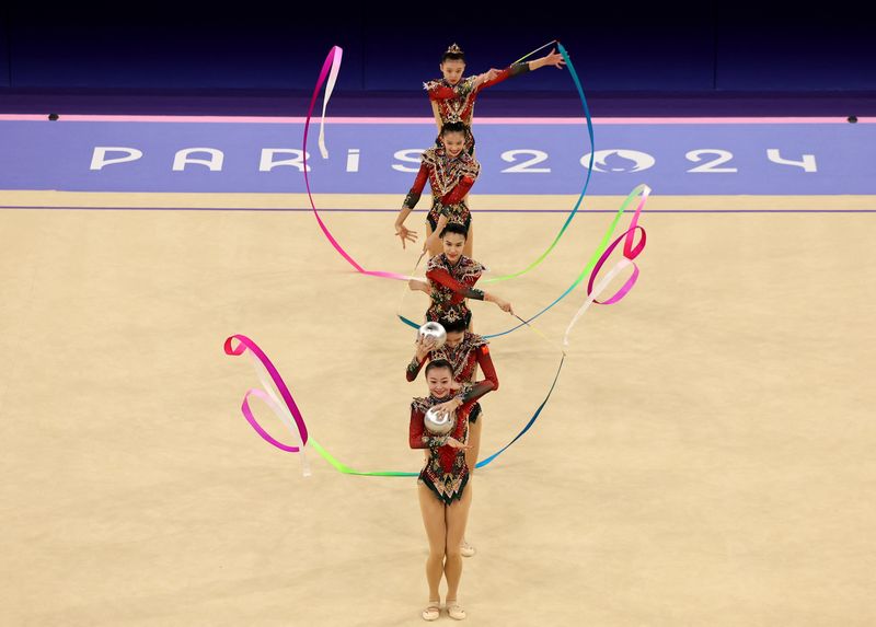 Paris 2024 Olympics - Rhythmic Gymnastics - Group All-Around Final - Porte de La Chapelle Arena, Paris, France - August 10, 2024. Gold medalists team People's Republic of China celebrate on the podium. REUTERS/Mike Blake