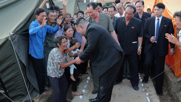 Momen Kim Jong Un Duduk Bareng dan Pangku Anak Korban Banjir North Korean leader Kim Jong Un greets people during a visit to the flood-affected area of ??Uiju County, North Pyongan Province, North Korea, in this photo released August 10, 2024. KCNA via REUTERS ATTENTION EDITORS - THIS IMAGE WAS PROVIDED BY A THIRD PARTY. REUTERS IS UNABLE TO INDEPENDENTLY VERIFY THIS IMAGE. NO THIRD PARTY SALES. SOUTH KOREA OUT. NO COMMERCIAL OR EDITORIAL SALES IN SOUTH KOREA. TPX IMAGES OF THE DAY