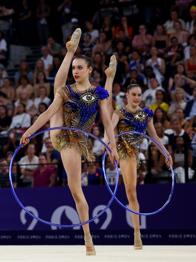Pada babak final, penampilan tim senam ritmik Israel ini mencuri atensi dengan kostumnya. Ada simbol mata satu pada busana berkilauan warna biru dan emas yang mereka kenakan.  Foto: REUTERS/Hannah McKay