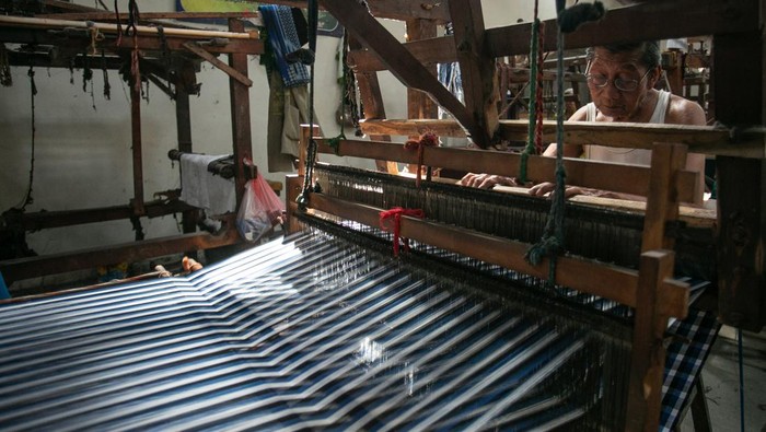 Melihat Pembuatan Kain Lurik Tradisional di Bantul Perajin menyelesaikan pembuatan tenun lurik menggunakan alat tenun bukan mesin di Kurnia Lurik, Krapyak, Panggungharjo, Sewon, Bantul, DI Yogyakarta, Selasa (13/8/2024). Menurut data Kementerian Koperasi dan UKM sekitar 64,2 juta pelaku UMKM menyumbang sekitar 61 persen Produksi Domestik Bruto (PDB) Indonesia dan pemerintah akan terus mendorong UMKM untuk lebih berkontribusi dalam pertumbuhan ekonomi nasional. ANTARA FOTO/Hendra Nurdiyansyah/rwa.