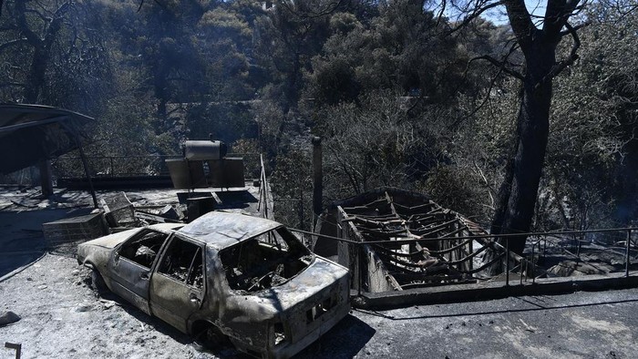 A damaged gym is seen in Nea Penteli, suburb of Athens, on Tuesday, Aug. 13, 2024, following a major wildfire that has burned into the northern suburbs of the Greek capital, triggered multiple evacuations. (AP Photo/Michael Varaklas)