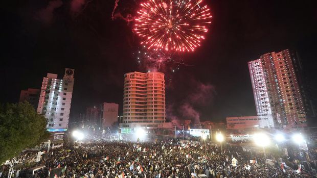 People gather to watch fireworks light the sky during the Pakistan Independence Day celebrations, in Karachi, Pakistan, Wednesday, Aug. 14, 2024. (AP Photo/Fareed Khan)