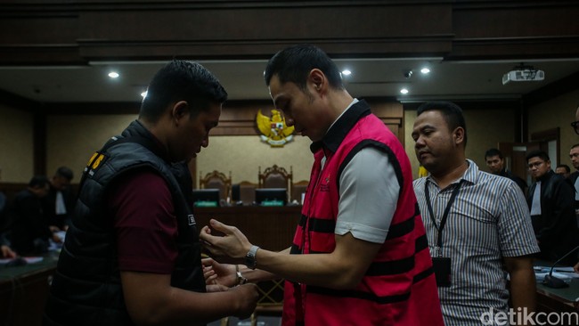 Di persidangan, kemewahan gaya Harvey tak lebih dari pakaian. Arloji favorit crazy rich seperti Rolex atau Patek Philippe seharga miliaran bahkan puluhan miliar yang biasa menemani ayah dua anak itu kini berganti jam tangan digital dan borgol. (Foto: Rifkianto Nugroho/detikcom)