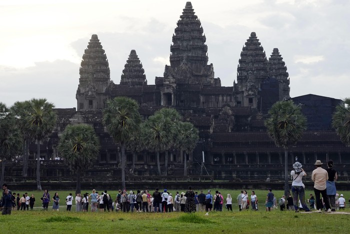 Tourists visit the Angkor Wat temple in Siem Reap province, Cambodia, Friday, Aug. 2, 2024. A centuries-old Angkor temple complex that sprawls across some 400 square kilometers (155 square miles), containing the ruins of capitals of various Cambodian empires from the 9th to the 15th century is the countrys most popular tourist attraction and in the first half of this year attracted more than half a million international tourists. (AP Photo/Heng Sinith)