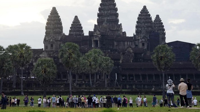 Tourists visit the Angkor Wat temple in Siem Reap province, Cambodia, Friday, Aug. 2, 2024. A centuries-old Angkor temple complex that sprawls across some 400 square kilometers (155 square miles), containing the ruins of capitals of various Cambodian empires from the 9th to the 15th century is the countrys most popular tourist attraction and in the first half of this year attracted more than half a million international tourists. (AP Photo/Heng Sinith)