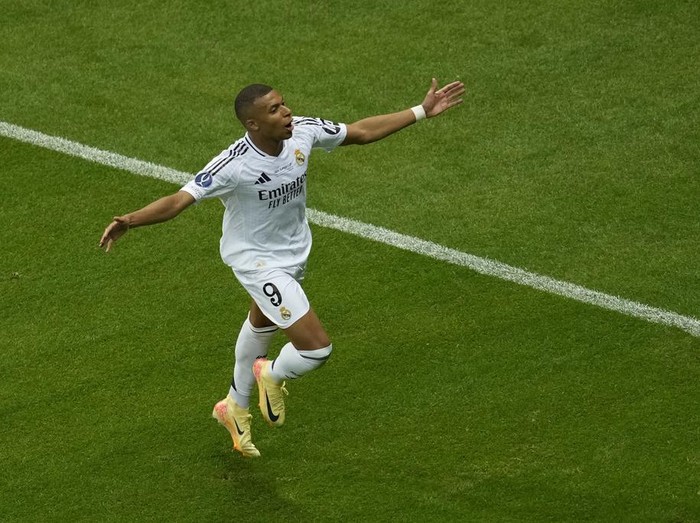 Real Madrids Kylian Mbappe, left, runs with the ball past Atalantas Ederson during the UEFA Super Cup Final soccer match between Real Madrid and Atalanta at the Narodowy stadium in Warsaw, Poland, Wednesday, Aug. 14, 2024. (AP Photo/Darko Vojinovic)
