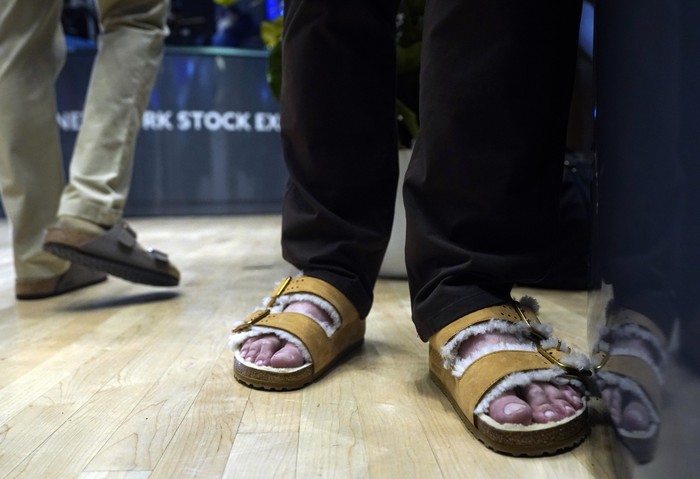 Traders on the floor of the New York Stock Exchange wear Birkenstock sandals during the companys IPO, Wednesday, Oct. 11, 2023, in New York. (AP Photo/Richard Drew)