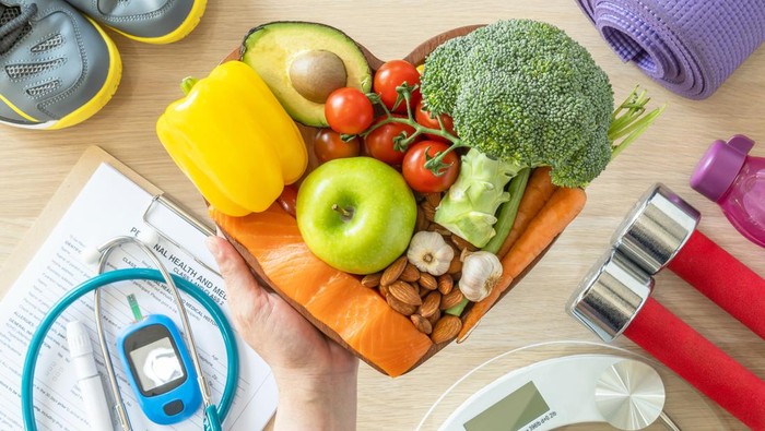 Healthy lifestyle on ketogenic diet, eating clean keto food good health dietary in heart dish with aerobic body exercise, gym workout training class , weight scale and sports shoes in fitness center