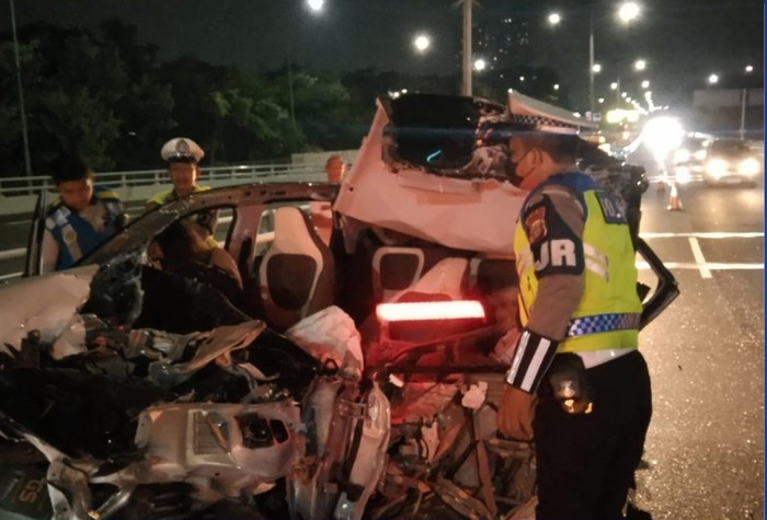 Kecelakaan mobil listrik dengan truk tronton terjadi di Tol Dalam Kota Jakarta. Mobil listrik mengalami kerusakan parah namun sopir selamat dalam insiden itu. (dok X @TMCPoldaMetro)
