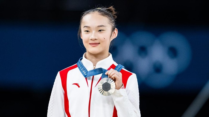 PARIS, FRANCE - AUGUST 5: Silver medalist Yaqin Zhou of Team China celebrates on the podium during the medal ceremony for the Artistic Gymnastics Womens Balance Beam Final on day ten of the Olympic Games Paris 2024 at the Bercy Arena on August 5, 2024 in Paris, France. (Photo by Tom Weller/VOIGT/GettyImages)
