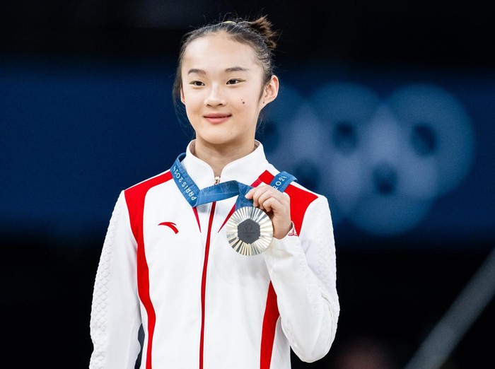 PARIS, FRANCE - AUGUST 5: Silver medalist Yaqin Zhou of Team China celebrates on the podium during the medal ceremony for the Artistic Gymnastics Womens Balance Beam Final on day ten of the Olympic Games Paris 2024 at the Bercy Arena on August 5, 2024 in Paris, France. (Photo by Tom Weller/VOIGT/GettyImages)