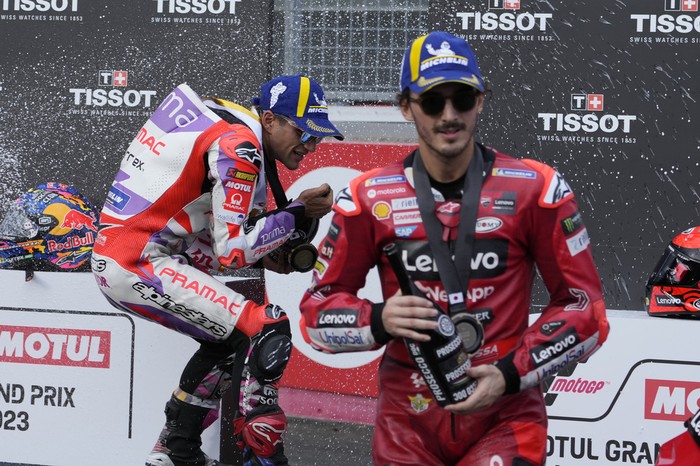 Winner Spains Jorge Martin, left, and third placed Italys Francesco Bagnaia spray champagne on the podium after the MotoGP sprint race at Japanese Motorcycle Grand Prix at the Twin Ring Motegi circuit in Motegi, north of Tokyo Saturday Sept. 30, 2023.(AP Photo/Shuji Kajiyama)