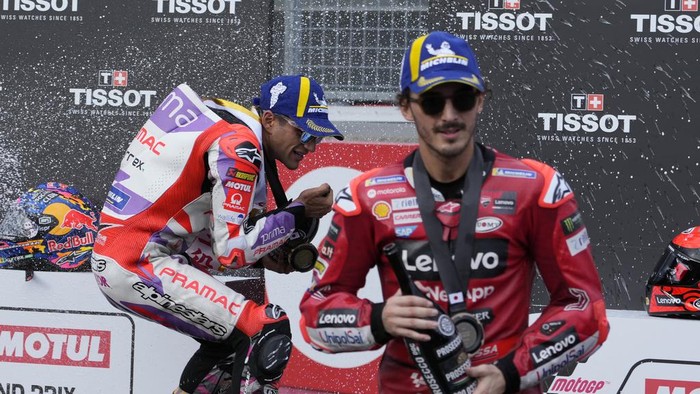 Winner Spains Jorge Martin, left, and third placed Italys Francesco Bagnaia spray champagne on the podium after the MotoGP sprint race at Japanese Motorcycle Grand Prix at the Twin Ring Motegi circuit in Motegi, north of Tokyo Saturday Sept. 30, 2023.(AP Photo/Shuji Kajiyama)