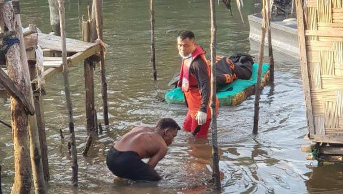 Petugas saat mengevakuasi jasad korban. (Dok. Polsek Medan Labuhan)