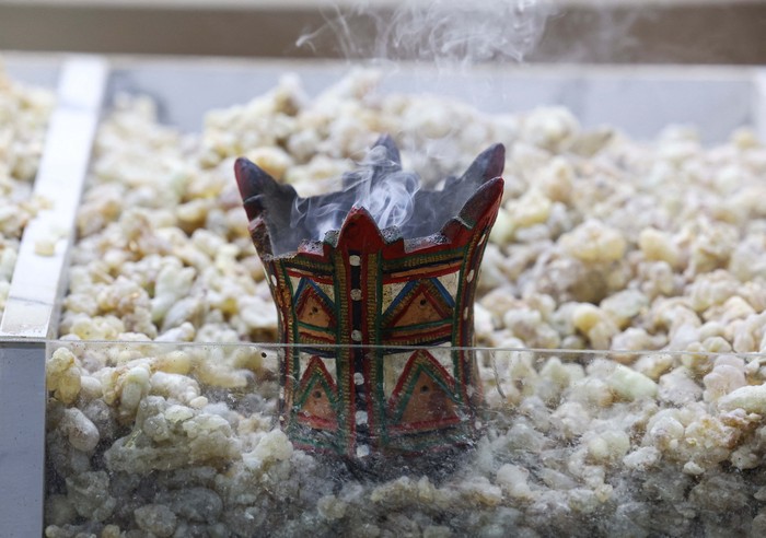 Frankincense, which is produced by Wadi Dawkahs trees and historically used to power trade routes beyond the Arabian Peninsula, burns on hot coals at Al Haffa Souq in Dhofar governorate, Oman, August 5, 2024. Frankincense remains a vital aspect of Omani culture, used in religious rites, incense, and perfumes. REUTERS/Rula Rouhana