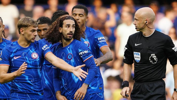 Chelsea players argue with referee Anthony Taylor during the English Premier League soccer match between Chelsea and Manchester City at Stamford Bridge stadium in London, England, Sunday, Aug, 18, 2024. (AP Photo/Dave Shopland)