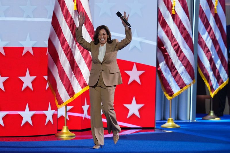 Democratic presidential nominee Vice President Kamala Harris raises her arms as she walks on stage during the Democratic National Convention Monday, Aug. 19, 2024, in Chicago. (AP Photo/J. Scott Applewhite)