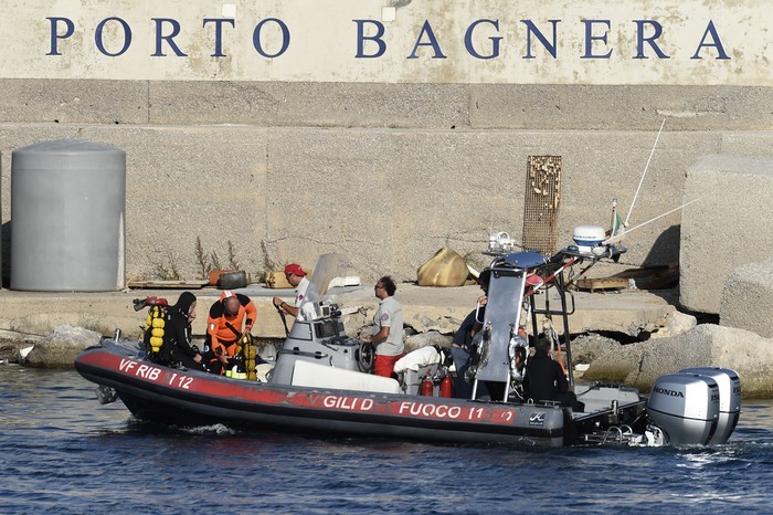 Emergency services at the scene of the search for a missing boat, in Porticello, southern Italy, Tuesday, Aug. 20, 2024. Rescue teams and divers returned to the site of a storm-sunken superyacht Tuesday to search for six people, including British tech magnate Mike Lynch, who are believed to be still trapped in the hull 50 meters (164-feet) underwater. (AP Photo/Salvatore Cavalli)