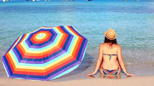 People sunbathing in Illetes, Formentera - Spain