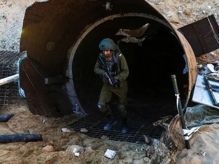 An Israeli soldier operates at the opening to what Israels military says is an iron-girded tunnel designed by Hamas to disgorge carloads of Palestinian fighters for a surprise storming of the border, amid the Israeli armys ongoing ground operation against Palestinian group Hamas, close to Erez crossing in the northern Gaza Strip, December 15, 2023. (Reuters)