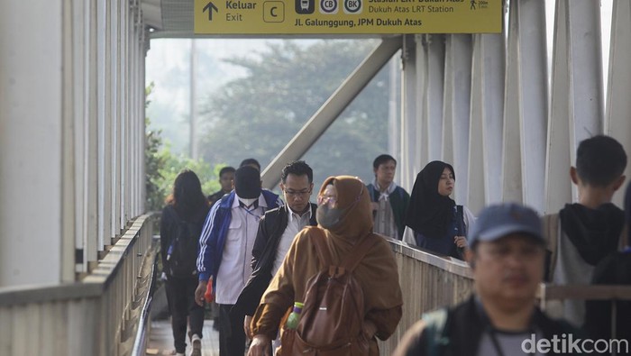 Sejumlah karyawan perkantoran melintasi kawasan Dukuh Atas, Setiabudi menuju tempat kerja di Jakarta, Jumat (23/8/2024).