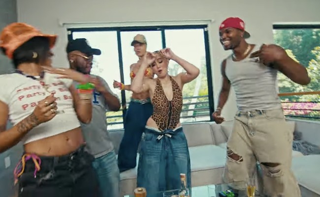 Atasan ketat tersebut dipadukannya dengan celana jeans baggy yang memberi kesan urban. (Foto: YouTube/Agnez Mo)