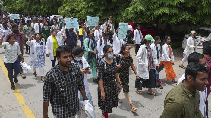 Doctors protesting against the alleged rape and killing of a trainee doctor at a government hospital in Kolkata, hold placards during a protest rally in Hyderabad, India, Thursday, Aug.22, 2024. (AP Photo/Mahesh Kumar A.)