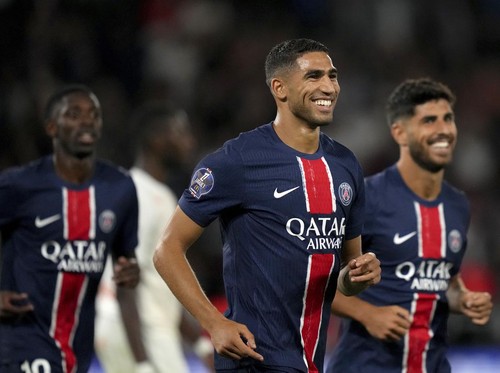 PSGs Achraf Hakimi smiles after scoring his sides fourth goal during the French League 1 soccer match between Paris Saint-Germain and Montpellier at the Parc des Princes in Paris, Friday, Aug. 23, 2024. (AP Photo/Thibault Camus)