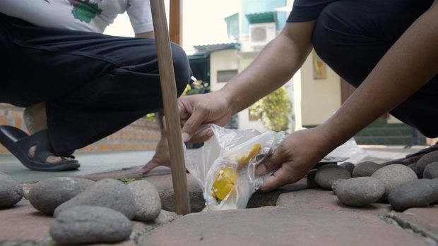 Mengisi lubang resapan biopori dengan sampah organik