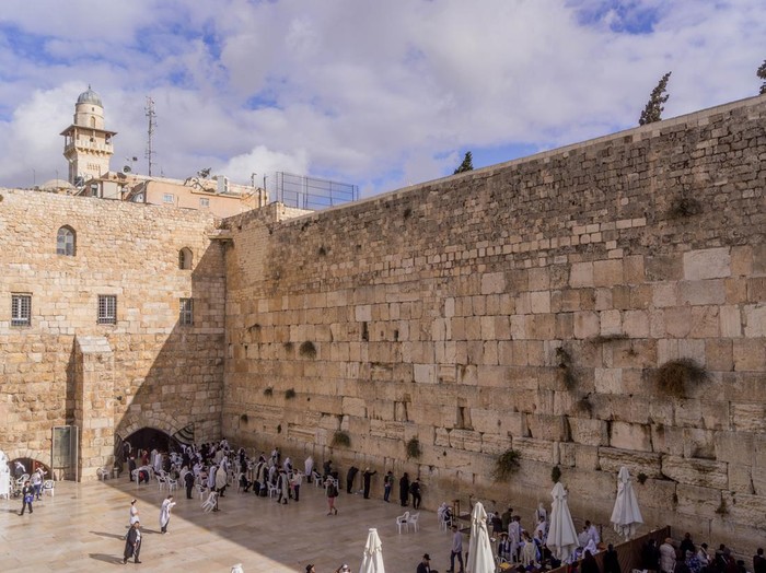 The Jewish people are praying at the Western Wall, a Judaism shrine, in Jerusalem, Israel.