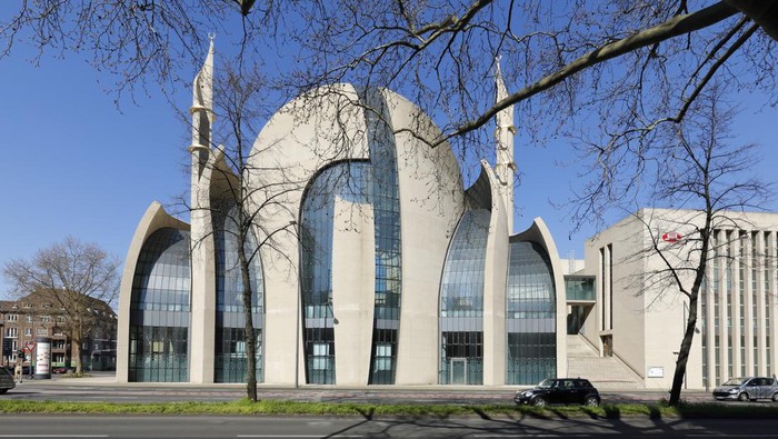 Cologne, Germany - April 01, 2020. The Central Mosque is designed by German architect Paul Böhm in non-Ottoman style - with concrete and glass. The building is one of the biggest mosque in Europe. Empty fast road (Innere Kanalstraße) in front.