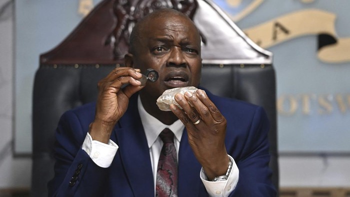 Botswana's President Mokgweetsi Masisi holds the 2,492-carat diamond that was unearthed at one of its mines and will be put on show, Thursday, Aug. 22, 2024, in Gaborone. (AP Photo)