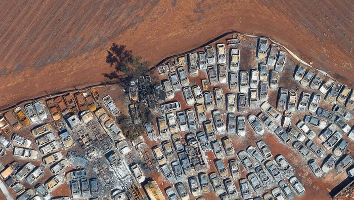 A drone view shows burned cars in a warehouse for vehicles seized by the police, after fires in sugar cane plantations near Dumont city, Sao Paulo state, Brazil, August 26, 2024. REUTERS/Joel Silva