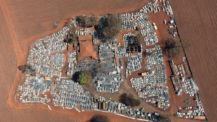 A drone view shows burned cars in a warehouse for vehicles seized by the police, after fires in sugar cane plantations near Dumont city, Sao Paulo state, Brazil, August 26, 2024. REUTERS/Joel Silva