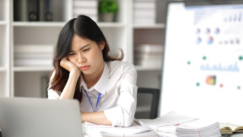 Asian women who are serious about working in the office are stressed by working too hard and missing deadlines.