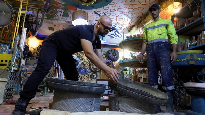 Egyptian entrepreneur Ibrahim Abougendy, owner of Mobikya, sits on a bed recycled out of industrial waste called 