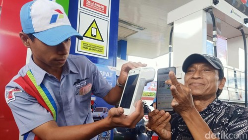 Petugas SPBU di Sunset Road, Bali, memindai QR Code pembelian Pertalite, Rabu (28/8/2024).