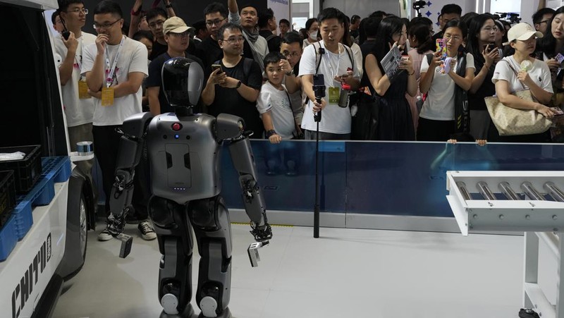Humanoid robots perform in synchrony at the World Robot Conference held in Beijing, Wednesday, Aug. 21, 2024. (AP Photo/Ng Han Guan)