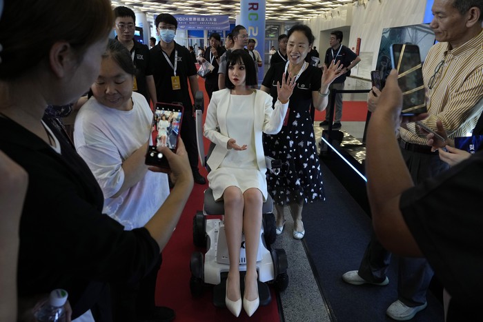 Humanoid robots perform in synchrony at the World Robot Conference held in Beijing, Wednesday, Aug. 21, 2024. (AP Photo/Ng Han Guan)
