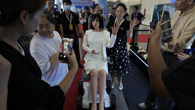 Humanoid robots perform in synchrony at the World Robot Conference held in Beijing, Wednesday, Aug. 21, 2024. (AP Photo/Ng Han Guan)