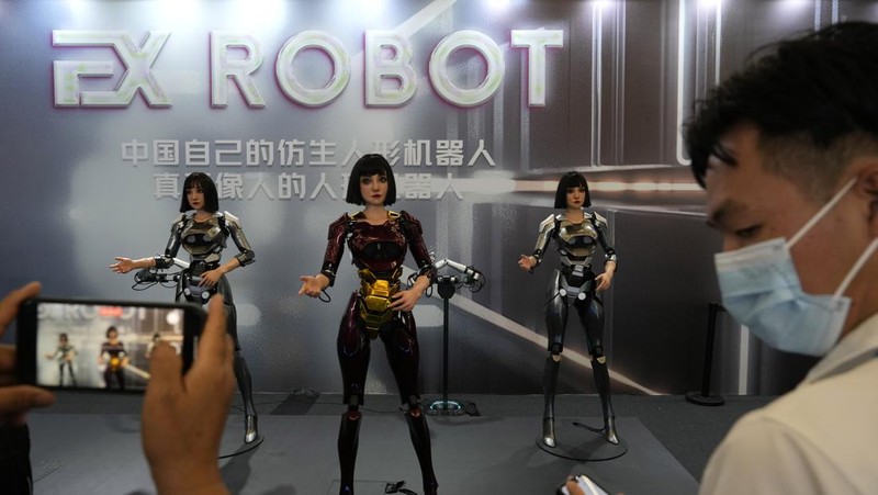 Humanoid robots perform in synchrony at the World Robot Conference held in Beijing, Wednesday, Aug. 21, 2024. (AP Photo/Ng Han Guan)