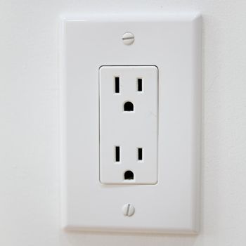 White Electrical Outlet and Wall Plate at the white wall