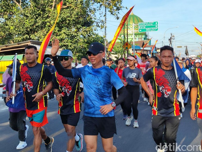 Sunaryanta-Mahmud Ardi saat berlari menuju kantor KPU Gunungkidul untuk mendaftarkan diri maju di Pilkada Gunungkidul 2024, Kamis (29/8/2024).