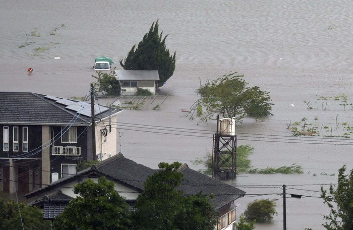 This aerial image shows the landslide in Gamagori, Aichi prefecture, Japan, Wednesday, Aug. 28, 2024. Ahead of the typhoons arrival, heavy rain caused a landslide that buried a house in the central city of Gamagori.  (Kyodo News via AP)