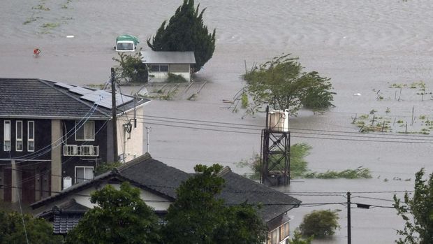 This aerial image shows the landslide in Gamagori, Aichi prefecture, Japan, Wednesday, Aug. 28, 2024. Ahead of the typhoon's arrival, heavy rain caused a landslide that buried a house in the central city of Gamagori.  (Kyodo News via AP)