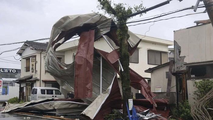 This aerial image shows the landslide in Gamagori, Aichi prefecture, Japan, Wednesday, Aug. 28, 2024. Ahead of the typhoon's arrival, heavy rain caused a landslide that buried a house in the central city of Gamagori.  (Kyodo News via AP)
